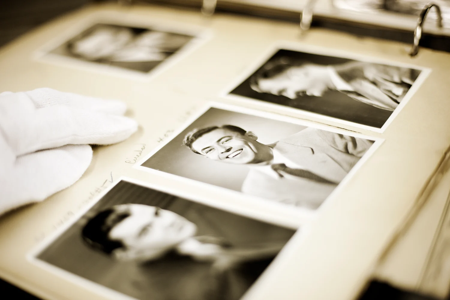 A black and white photo album with vintage portraits.