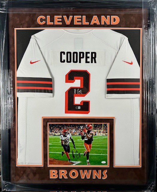 Framed Cleveland Browns jersey of Cooper with a photo below.