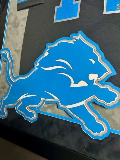 A blue lion emblem on a black background.