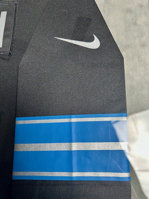 Close-up of a Nike garment with blue and white stripes.