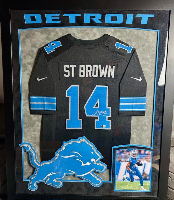 Framed Detroit Lions jersey of St. Brown with number 14.