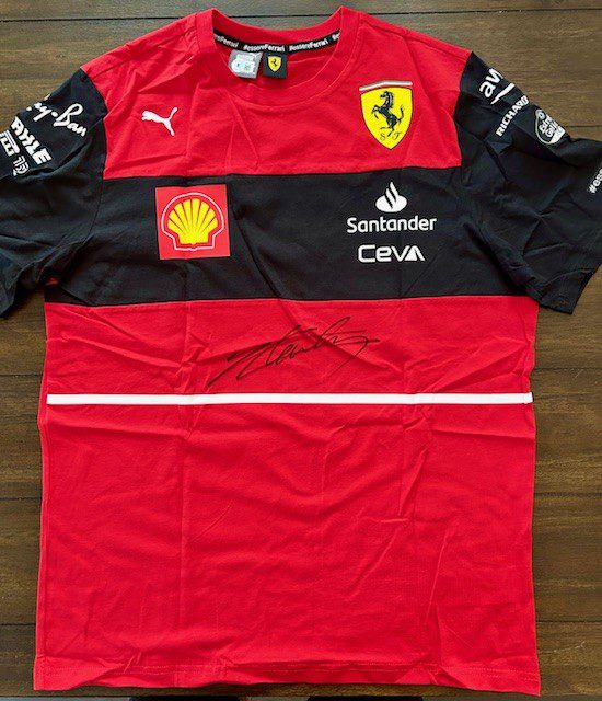 Red and black Ferrari racing team shirt with sponsors.