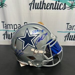 A Dallas Cowboys football helmet with a blue faceguard and signatures.
