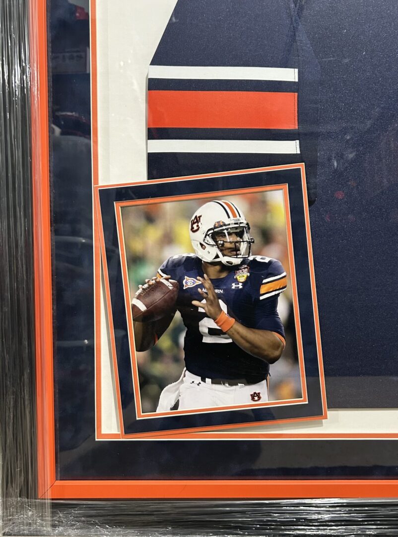 Framed football player photo in action pose.