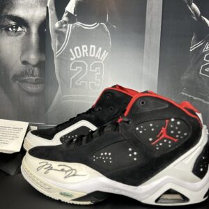Autographed basketball shoes with Jordan poster.