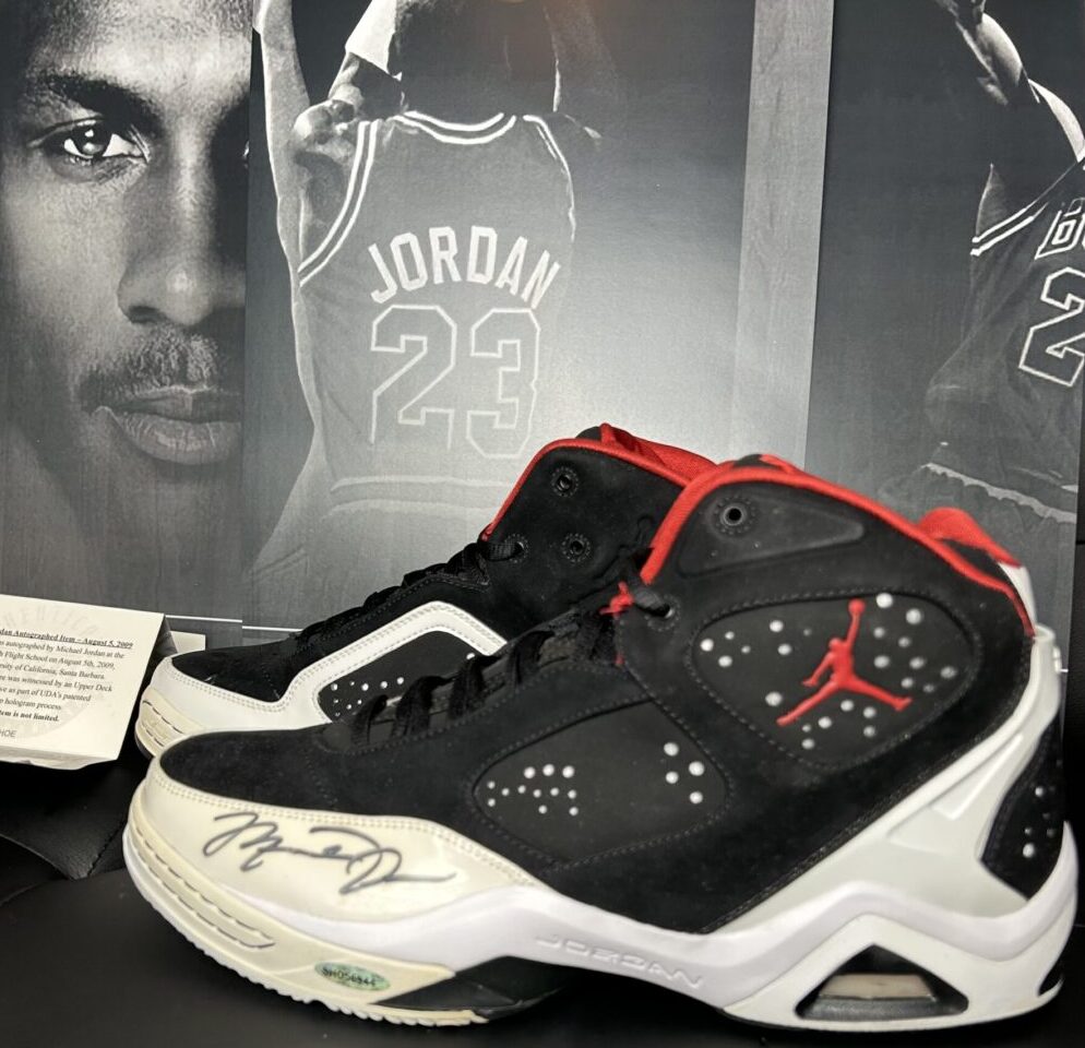 Autographed basketball shoes with Jordan poster.