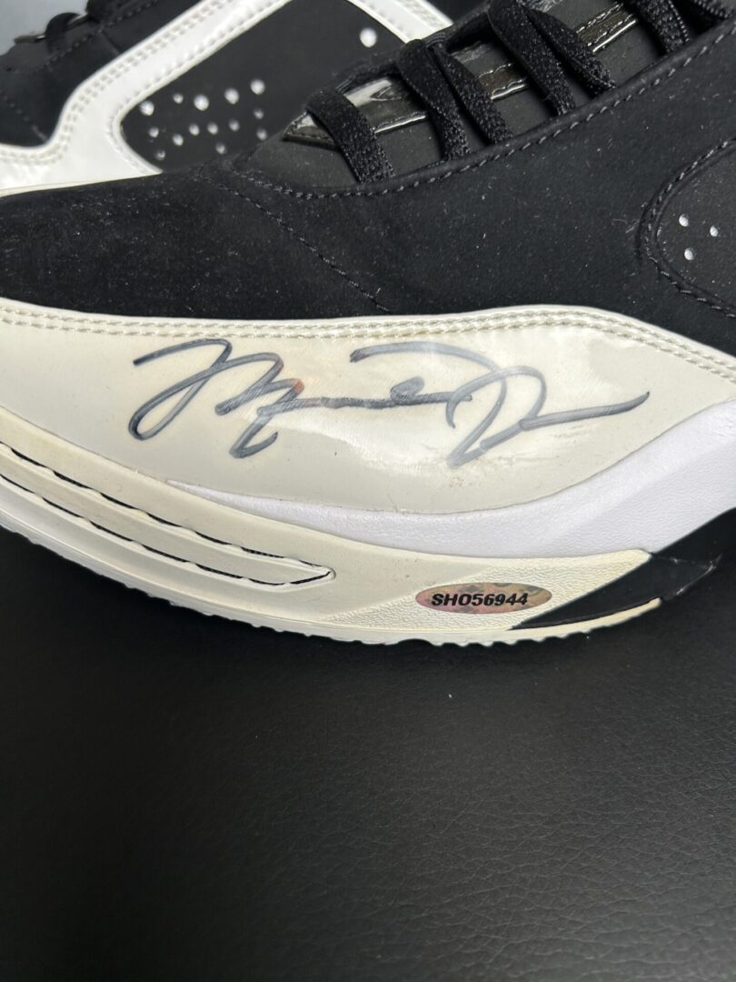 Black and white sneaker with signature detail.
