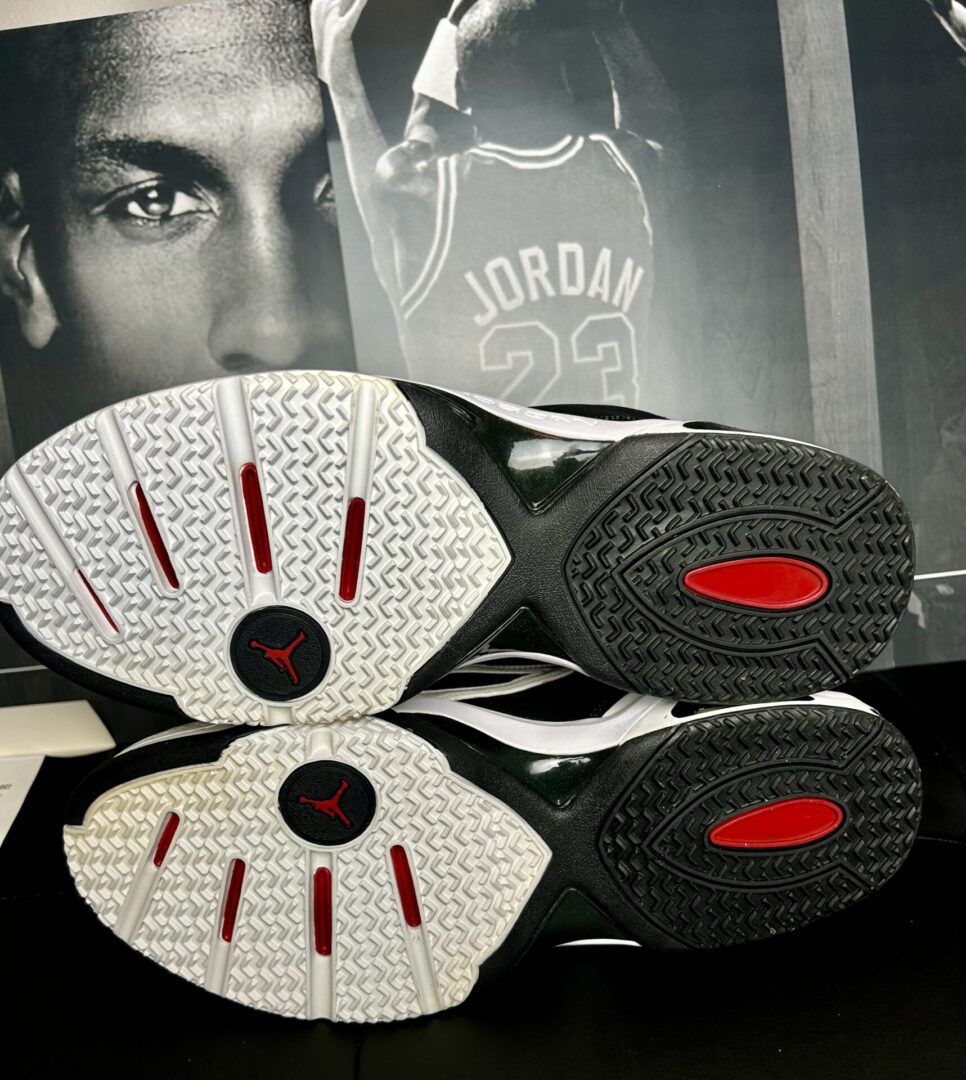 Sneaker soles with basketball player poster background.