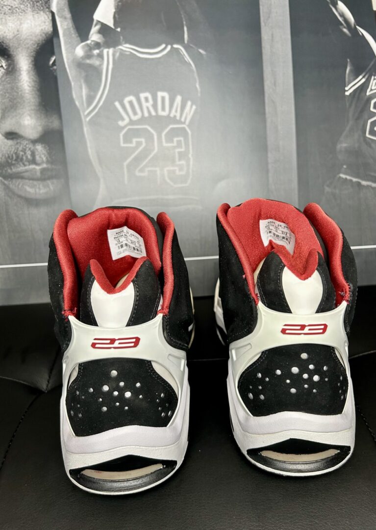 Red and black basketball shoes, Michael Jordan poster.