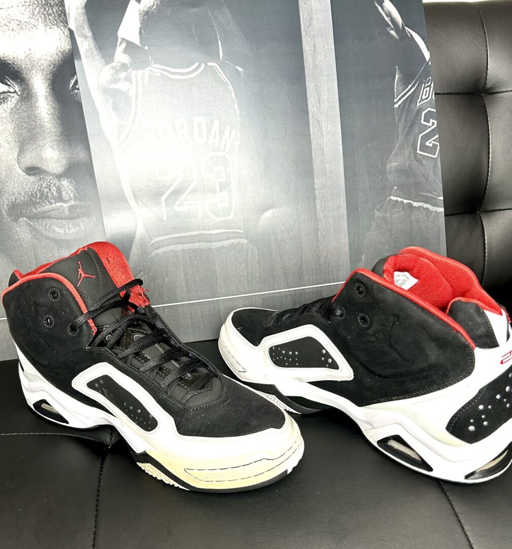 Black and white sneakers with red accents.