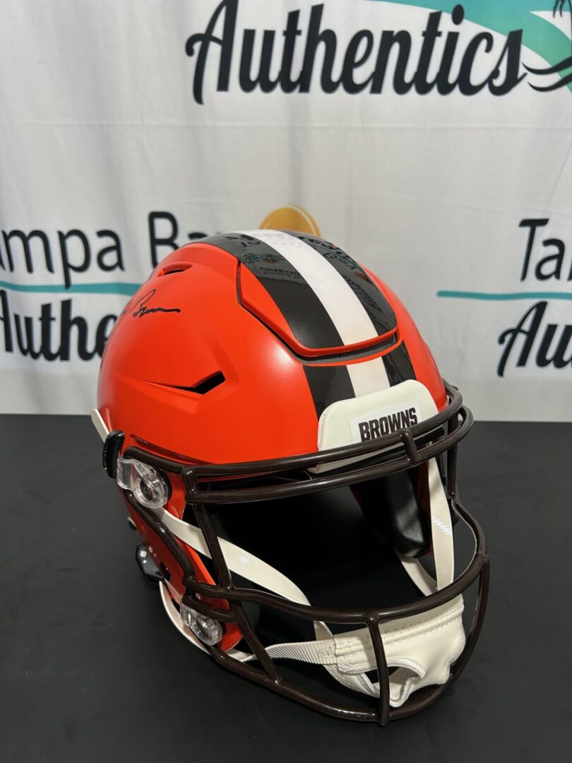 A red football helmet with a black and white stripe down the center.