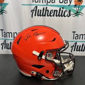 Orange football helmet with autographs on display.
