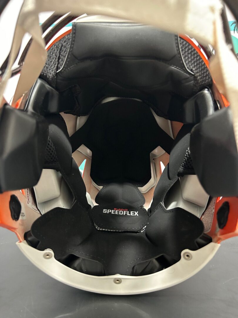 Inside view of a sports helmet showing padding and straps.