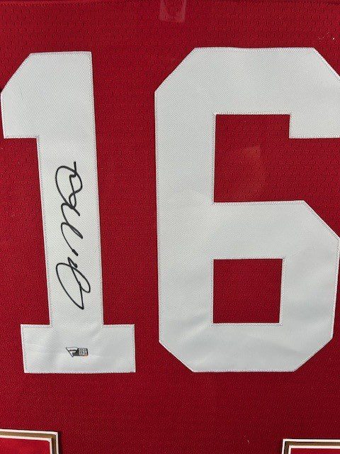 Close-up of a red sports jersey number 16 with an autograph.