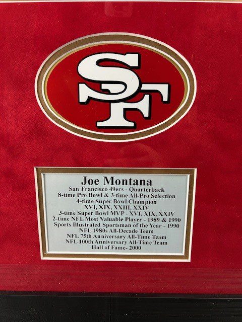 San Francisco 49ers logo with Joe Montana plaque.