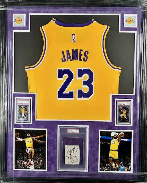 A framed LeBron James Lakers jersey number 23 with photos and memorabilia.