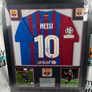 Framed Lionel Messi Barcelona jersey with memorabilia.