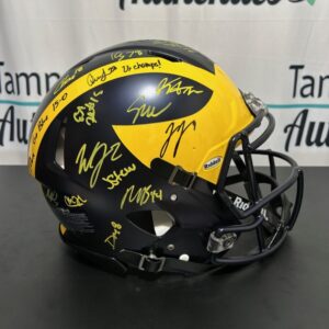 Black and yellow football helmet with multiple signatures.