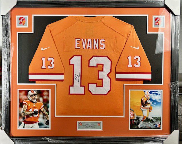 Framed orange football jersey with number 13 and name Evans.