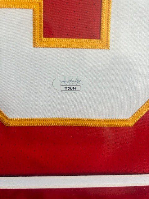 Close-up of a textile label on a red and white fabric.
