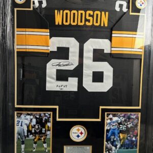 Framed football jersey with photographs and signature.