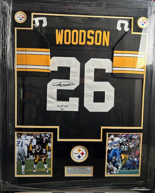 Framed football jersey with photographs and signature.
