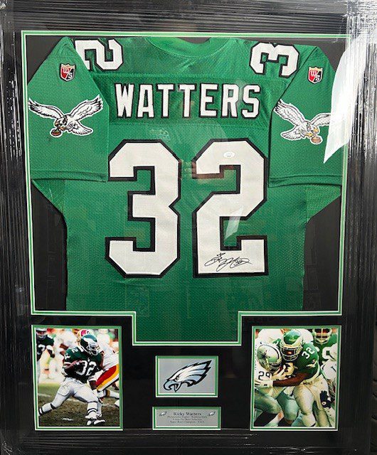 Framed green football jersey with action photos.