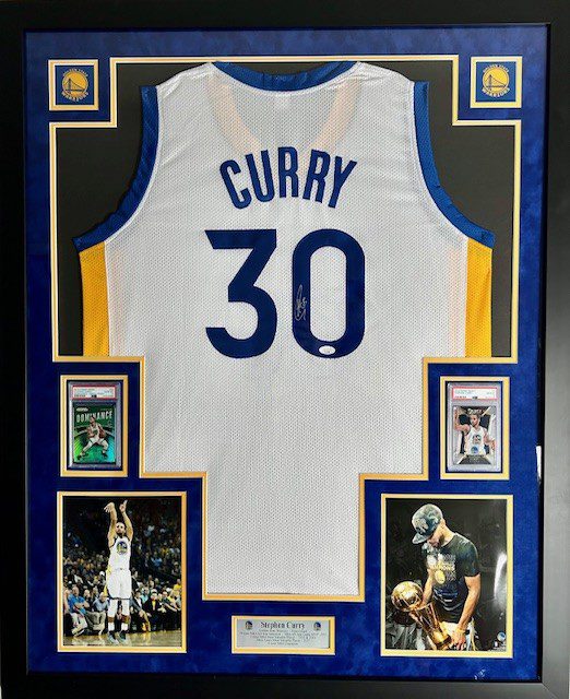 Framed Stephen Curry jersey with memorabilia.
