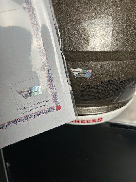 A letter with a butterfly stamp next to a microwave.