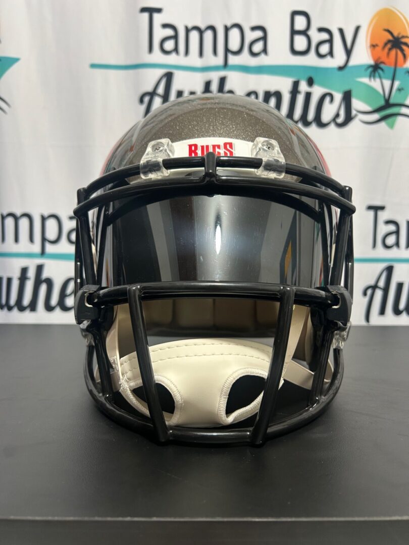 Front view of a black football helmet with a tinted visor.