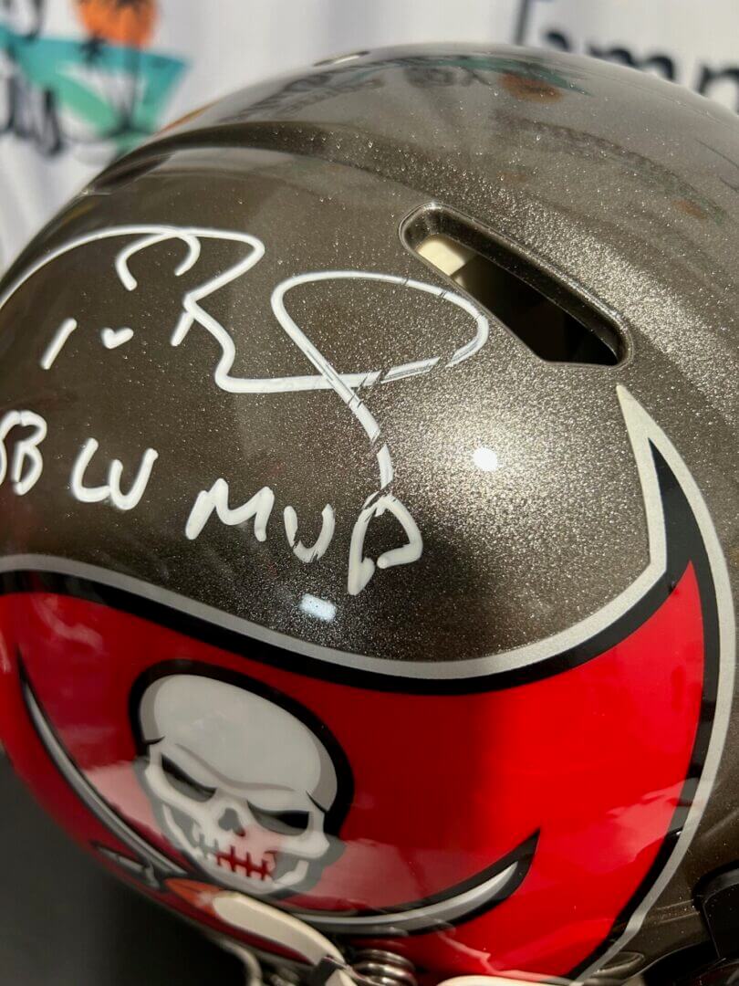 A close-up of a signed Tampa Bay Buccaneers helmet.