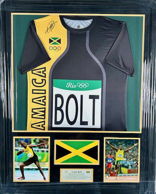 A Usain Bolt Jamaica track jersey with memorabilia.
