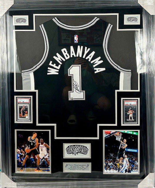 A framed black basketball jersey with the name 'Membanyah' and number 1.
