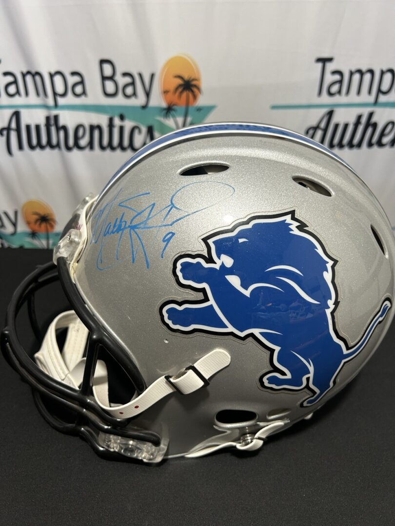Signed Detroit Lions football helmet on display.