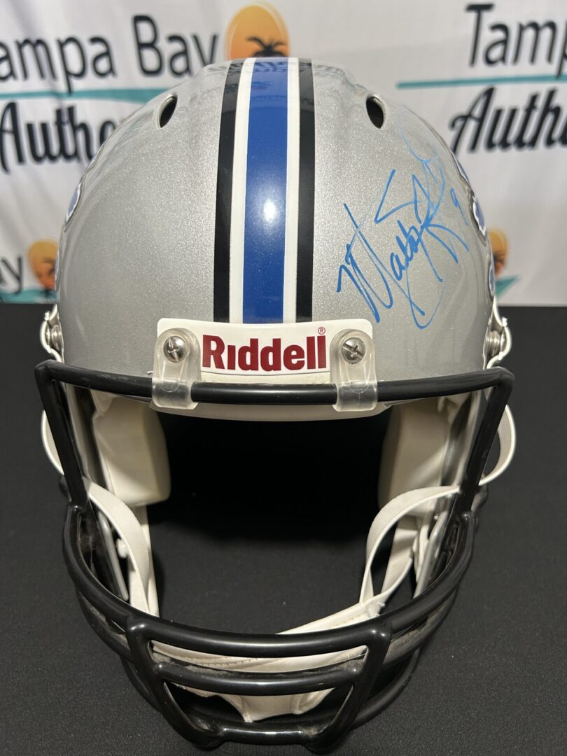 Signed football helmet with blue stripes.