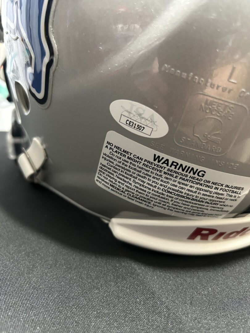 Silver football helmet warning and certification stickers