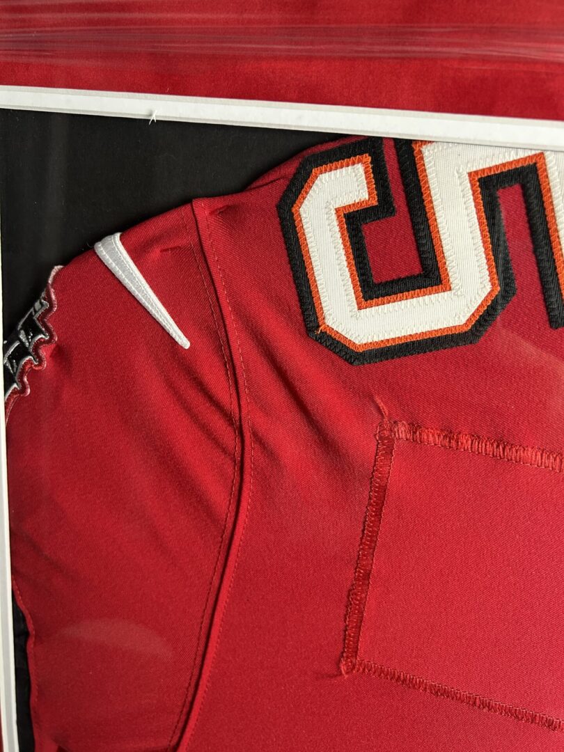 Red sports jersey with number detail.