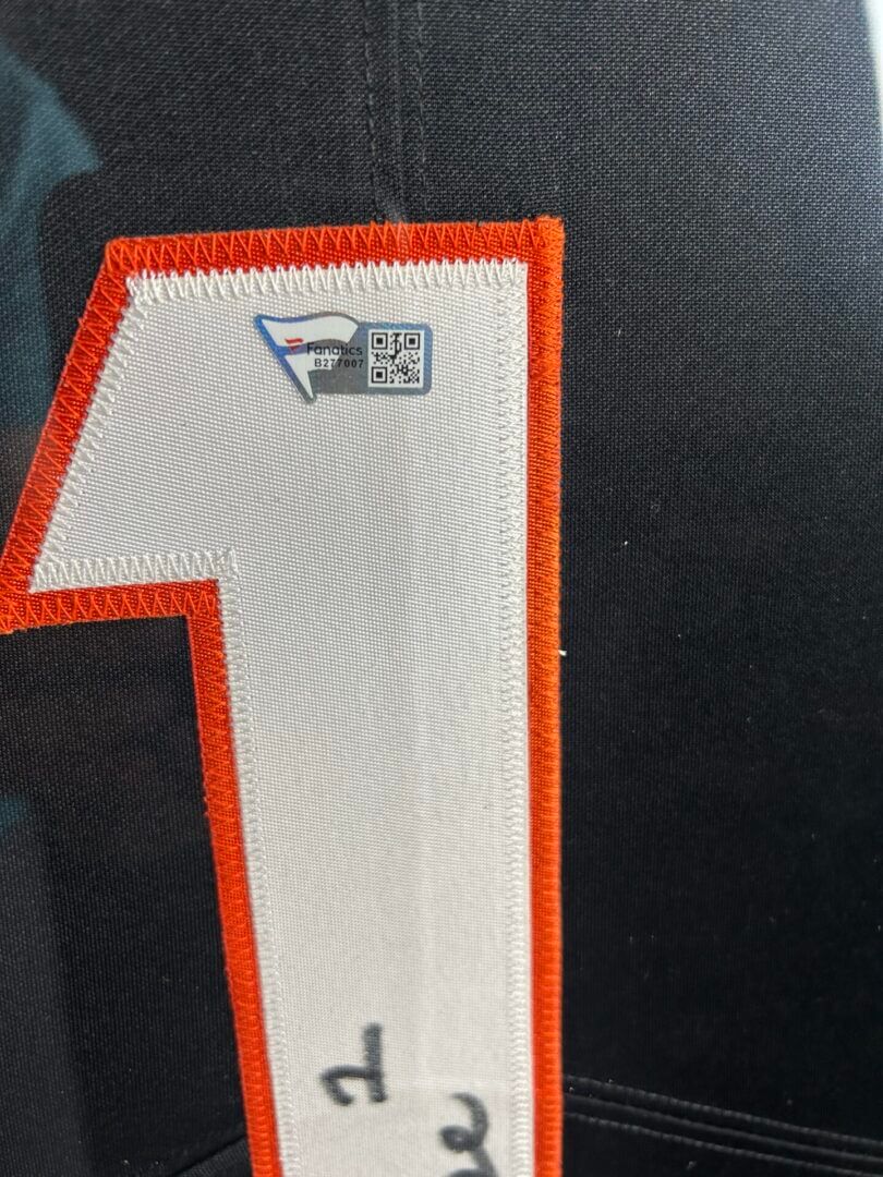 Number one on black fabric with stitching.
