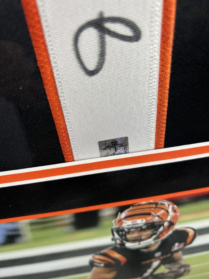 Framed sports memorabilia with football player.