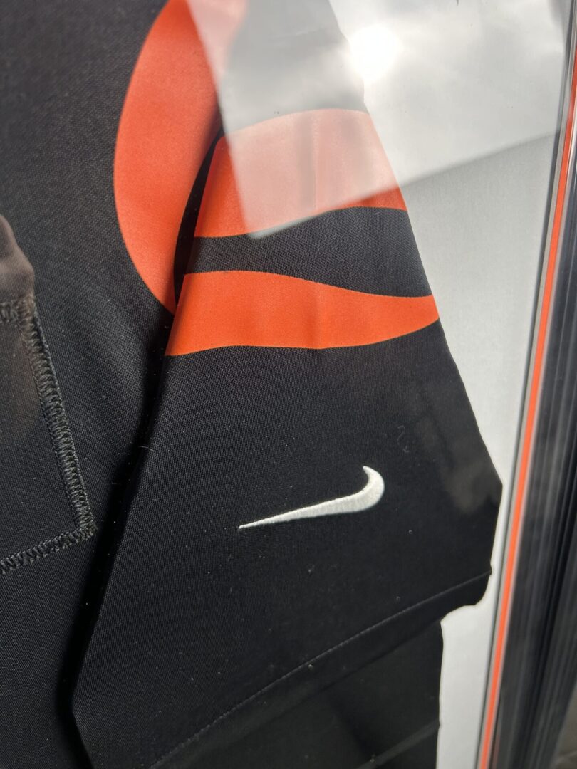 Black and orange Nike jersey in frame.
