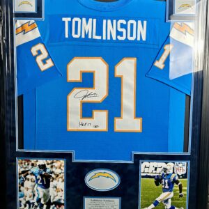 Framed signed football jersey with action photos.
