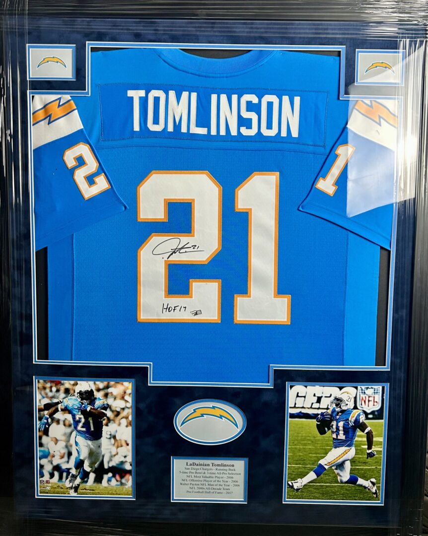 Framed signed football jersey with action photos.