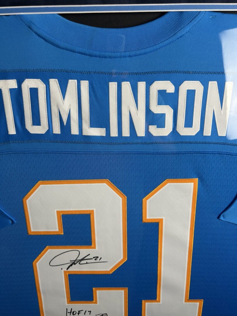 Blue football jersey with Tomlinson's autograph.